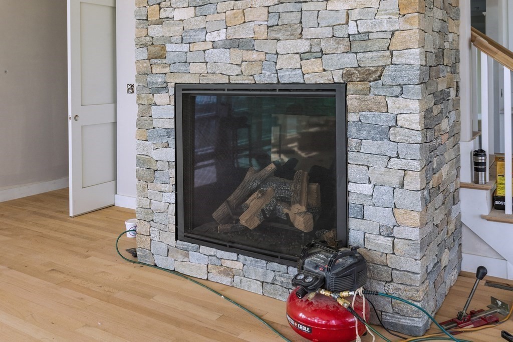 169 Atlantic Road Gloucester, MA 01930 - Photo 13 of 24 a room with a fireplace and wooden floor