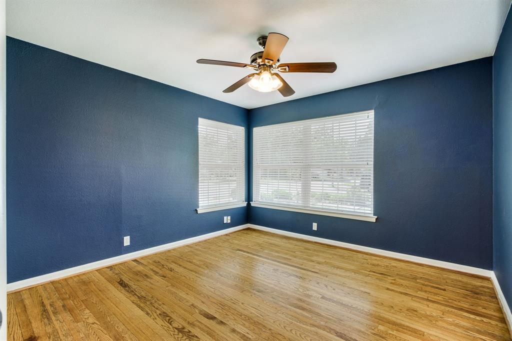 700 Ridgedale Drive Richardson, TX 75080 - Photo 22 of 32 Secondary bedroom with large windows and a ceiling fan.