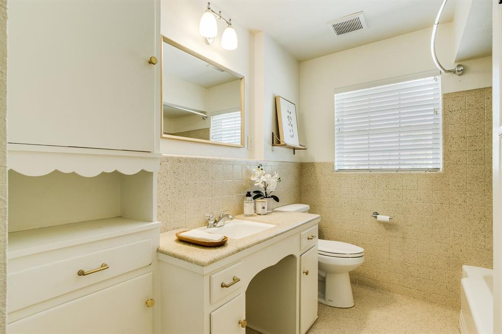 700 Ridgedale Drive Richardson, TX 75080 - Photo 24 of 32 Secondary bathroom with ample storage and a bathtub/shower combo.