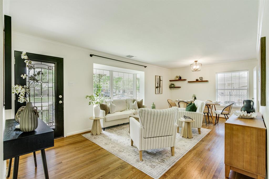 700 Ridgedale Drive Richardson, TX 75080 - Photo 7 of 32 The welcoming entrance features wood flooring and a glass-paneled front door leads into a cozy family room.