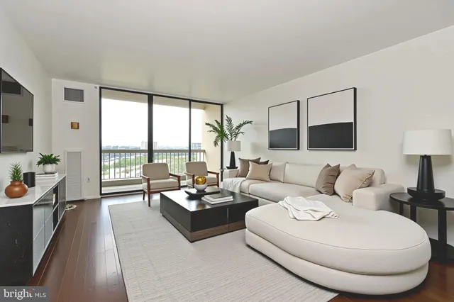 a living room with furniture and a large window