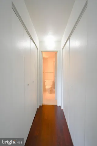 a view of hallway with wooden floor