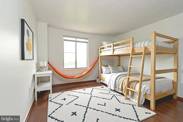 a bedroom with a bed a mirror and a window