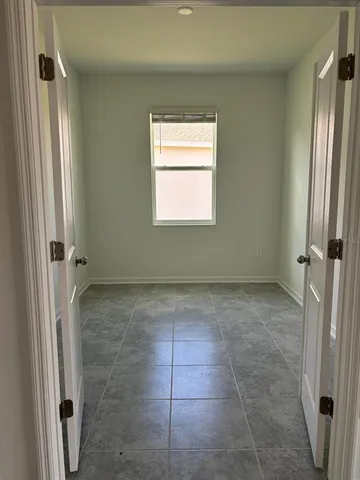 a bathroom with a granite countertop shower a window and a sink