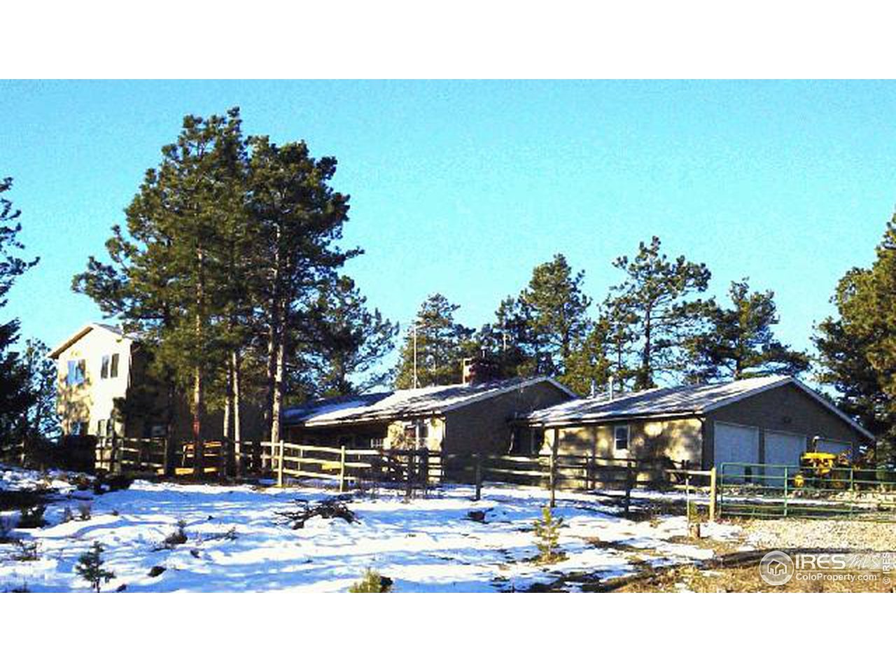 228 Stratton Park Road Bellvue, CO 80512 - Photo 1 of 12 a backyard of a house with table and chairs