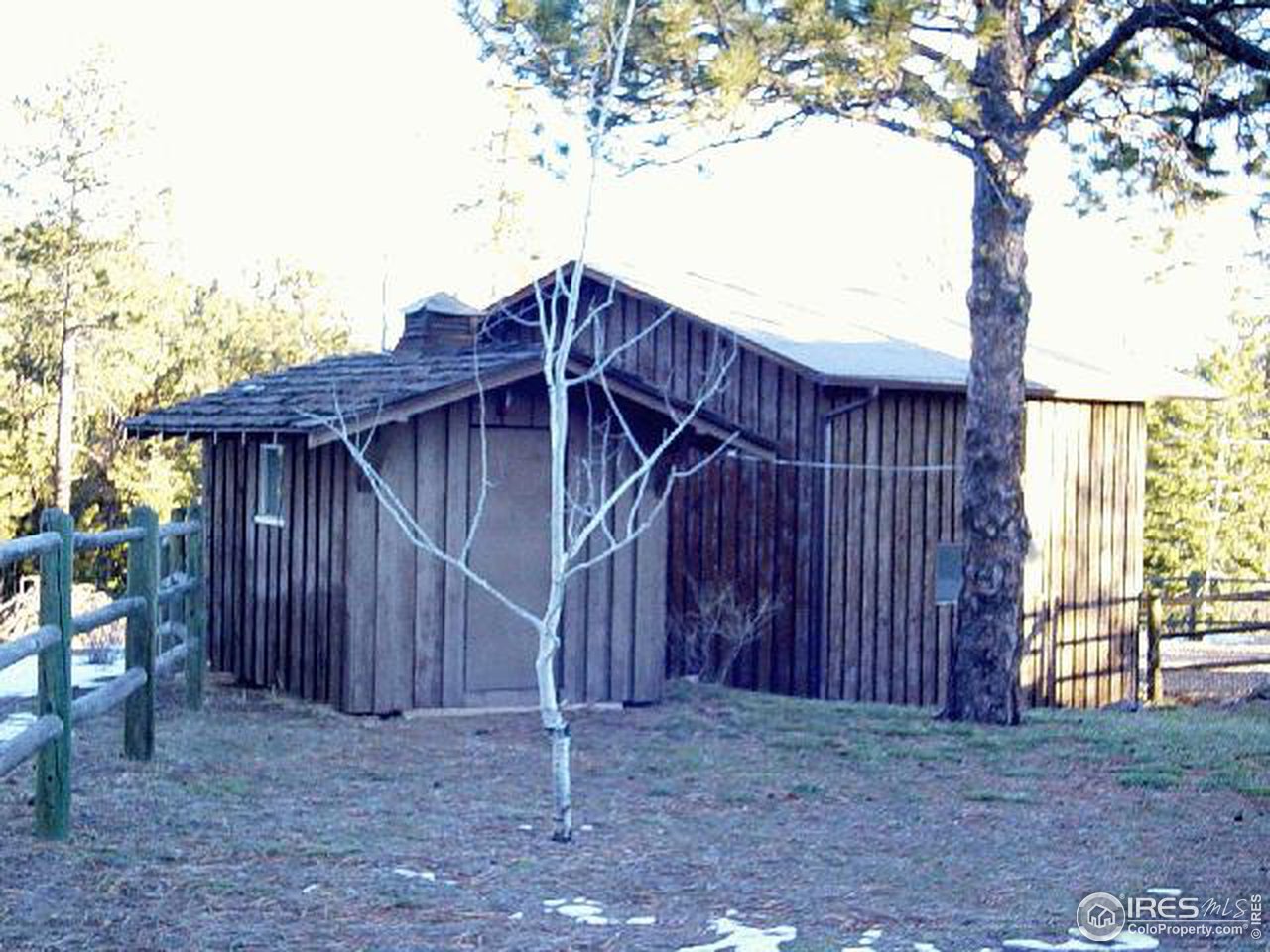 228 Stratton Park Road Bellvue, CO 80512 - Photo 4 of 12 a wooden house with a large tree in front of it