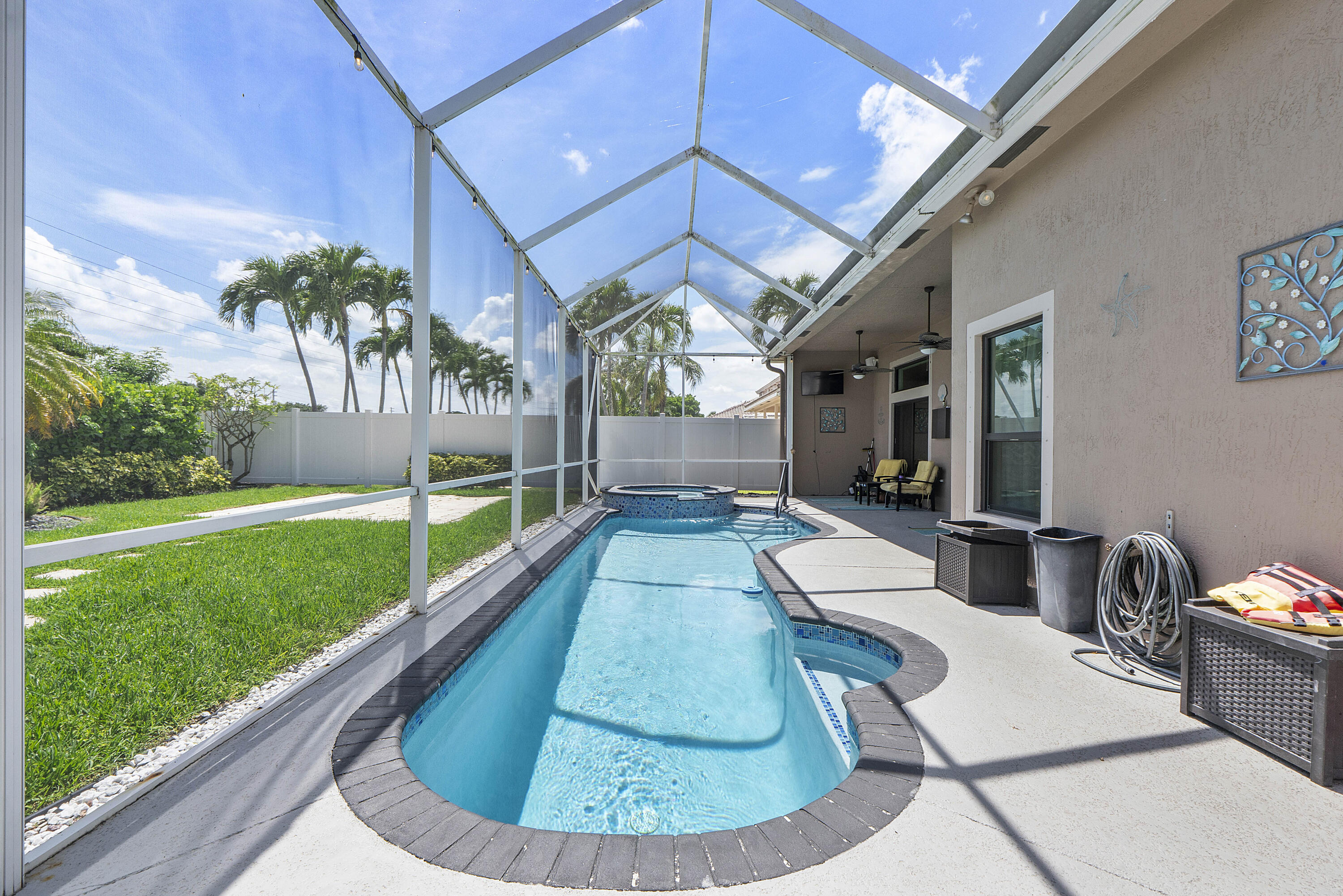 12328 St Simon Drive Boca Raton, FL 33428 - Photo 34 of 52 a view of a swimming pool with a patio