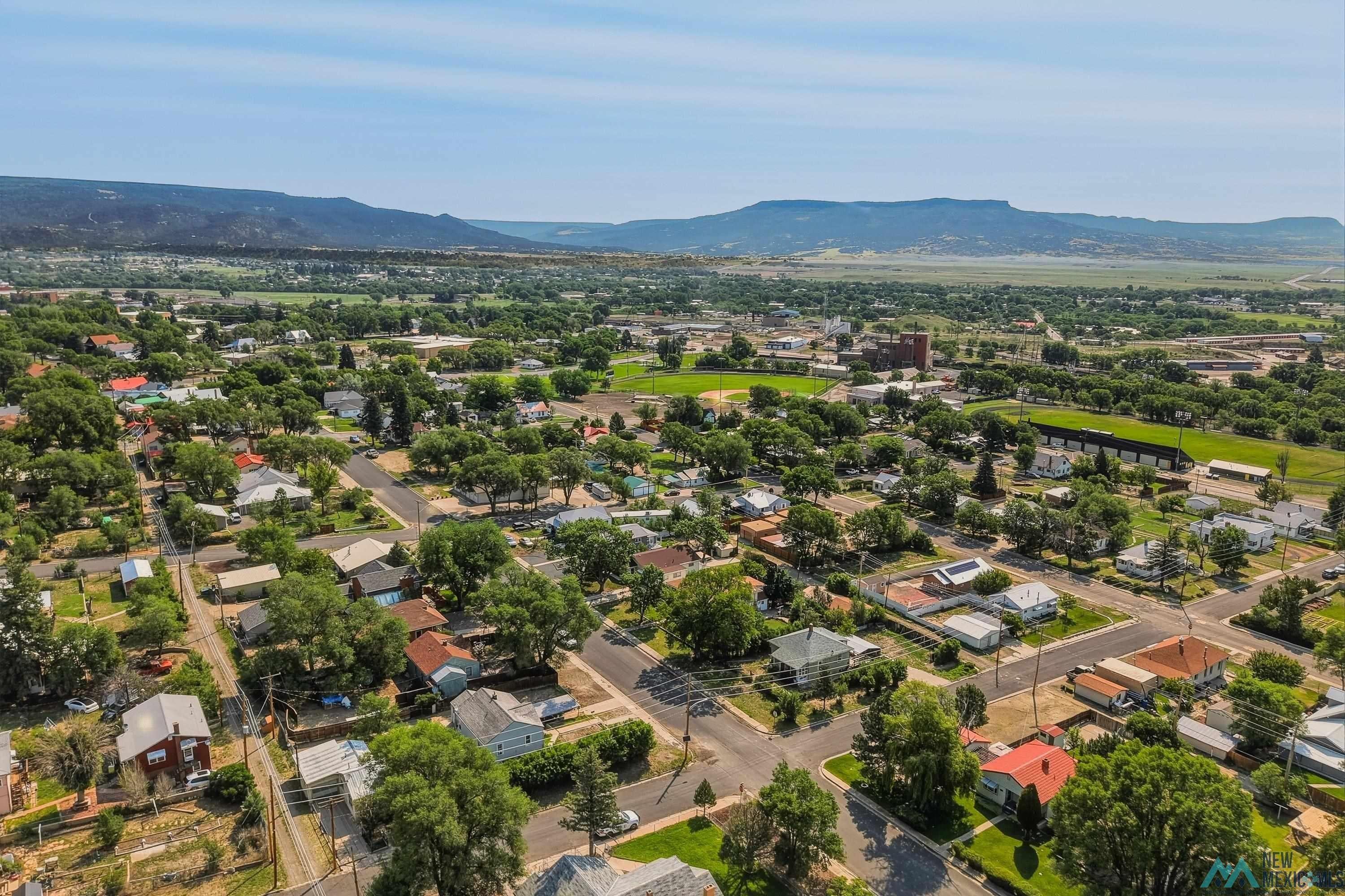 1026 South 5th Street Raton, NM 87740 - Photo 29 of 33 Aerial perspective showcasing a residential area with mature trees and varied architectural styles