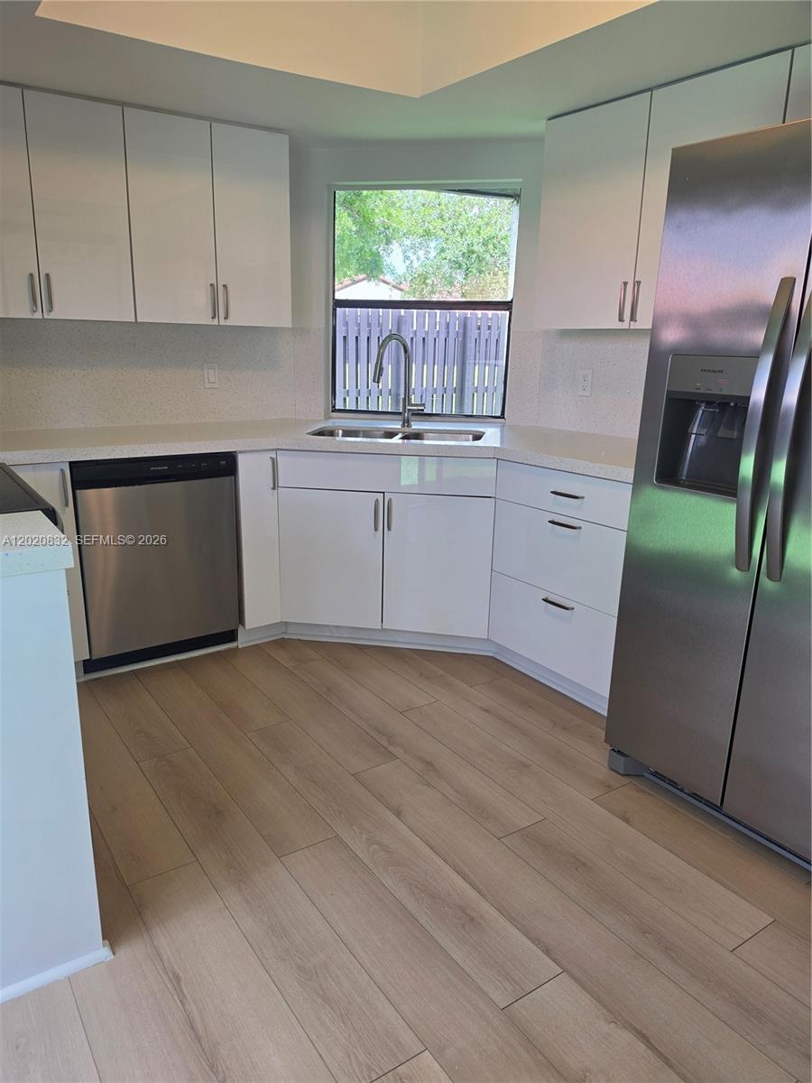 15240 Southwest 45th Terrace, Unit 54F Miami, FL 33185 - Photo 23 of 48 a kitchen with white cabinets and window