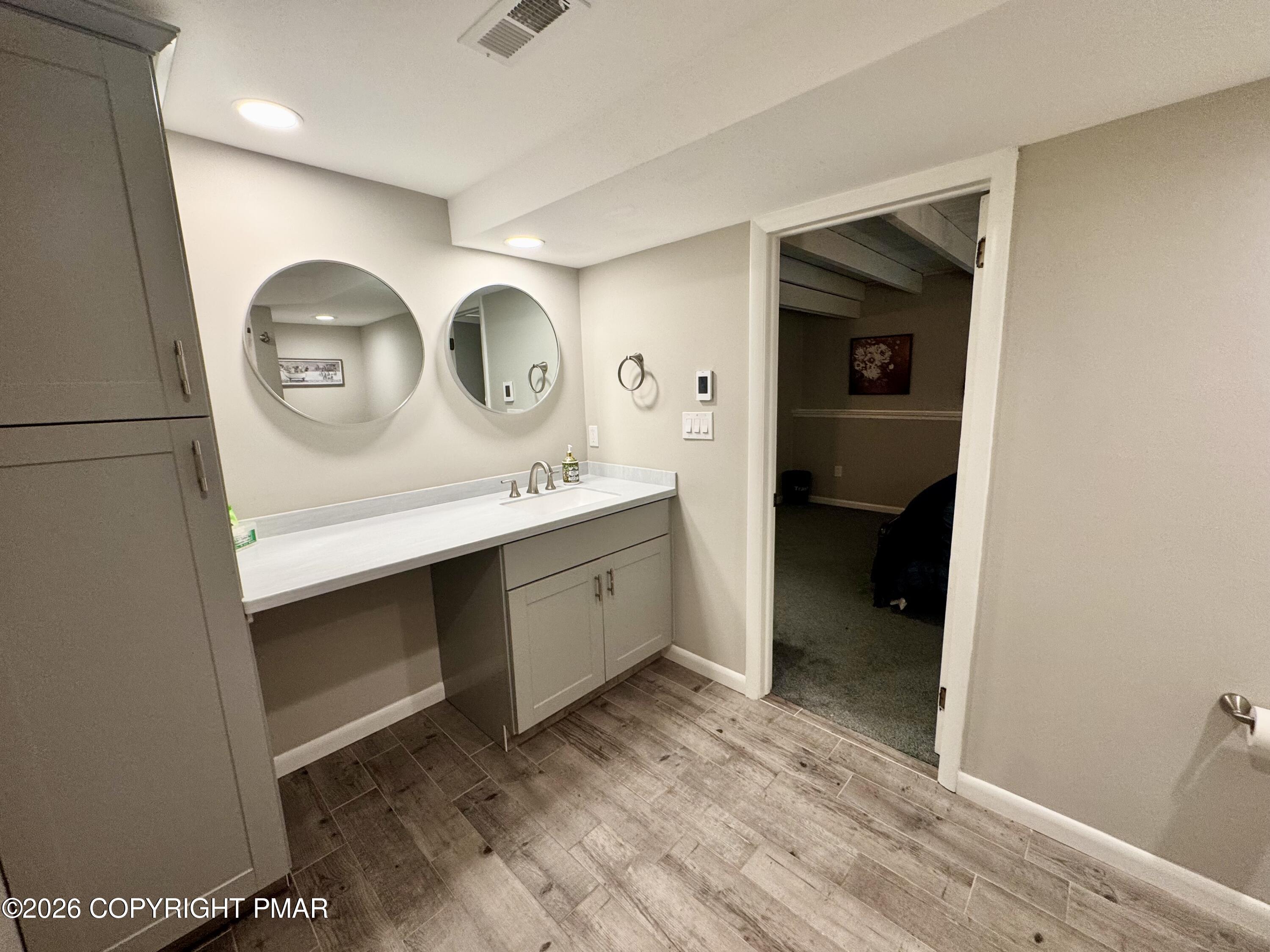 9 Sassafras Road Lake Harmony, PA 18624 - Photo 18 of 35 a room with a sink a vanity and a mirror