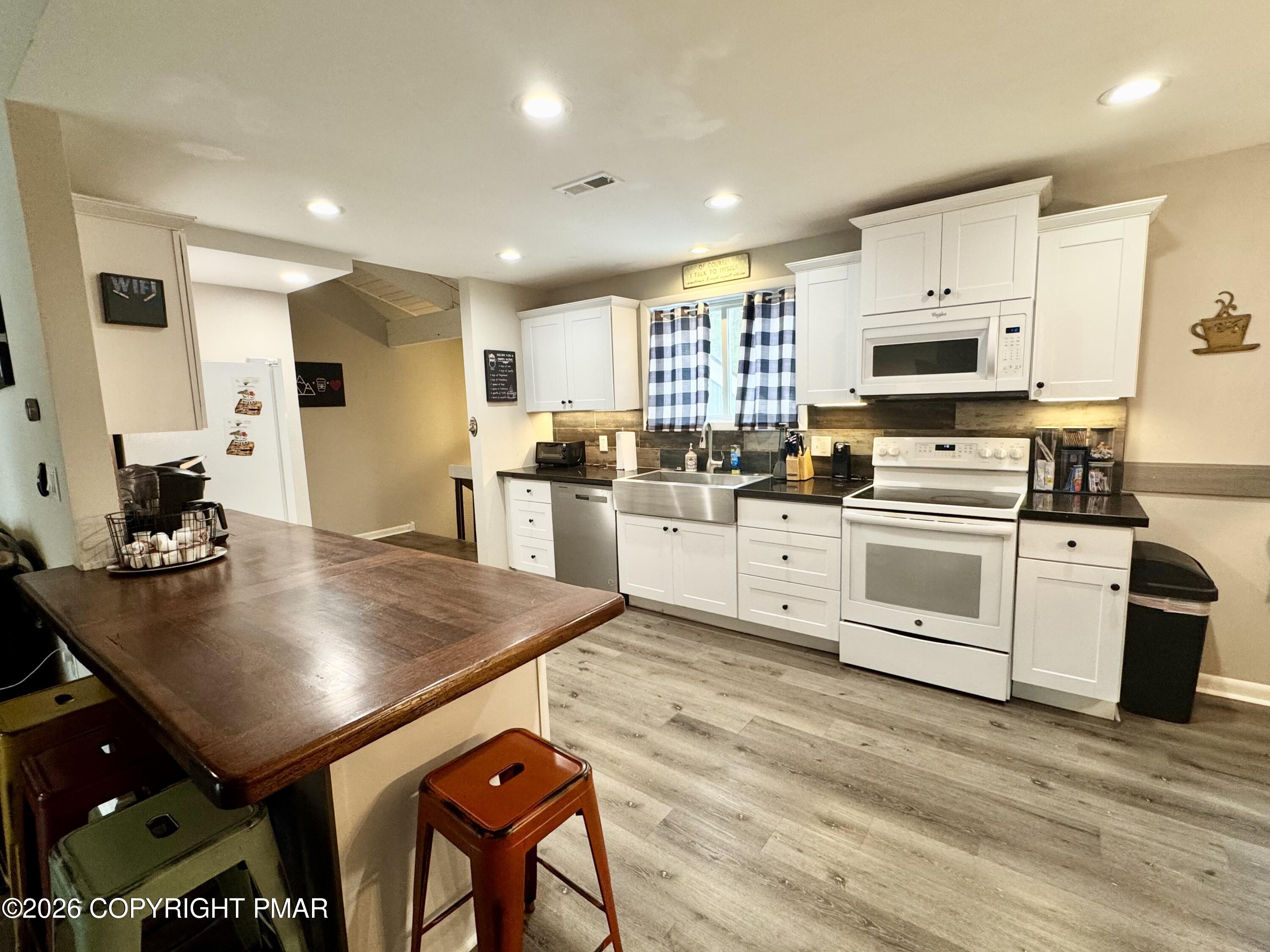 9 Sassafras Road Lake Harmony, PA 18624 - Photo 8 of 35 a kitchen with a stove a sink and a refrigerator