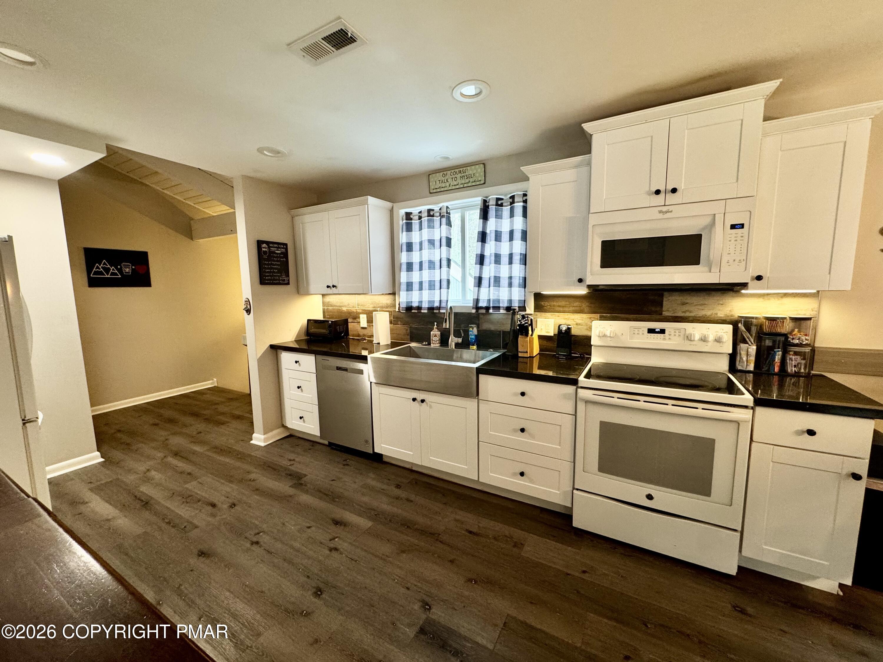 9 Sassafras Road Lake Harmony, PA 18624 - Photo 9 of 35 a kitchen with stainless steel appliances granite countertop a stove a sink and a microwave