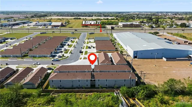 an aerial view of residential houses with outdoor space