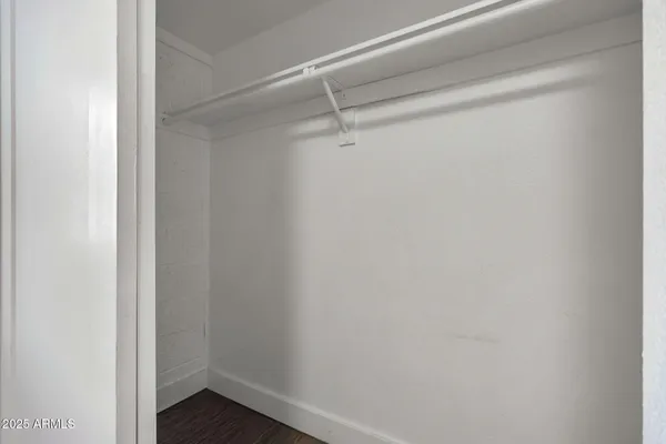 a bathroom with a granite countertop sink a toilet and a mirror