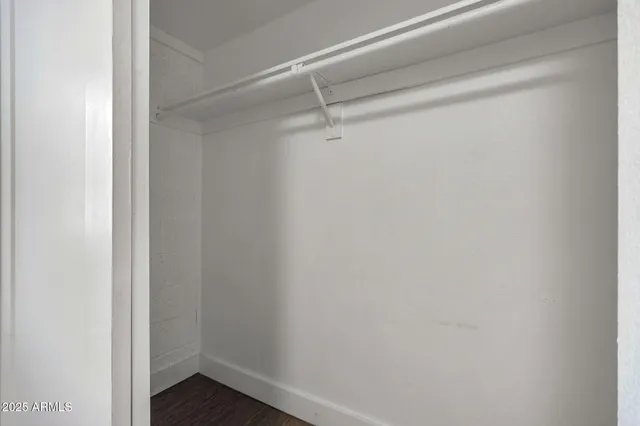 a bathroom with a granite countertop sink a toilet and a mirror