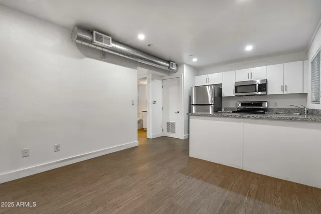 a view of kitchen with wooden floor