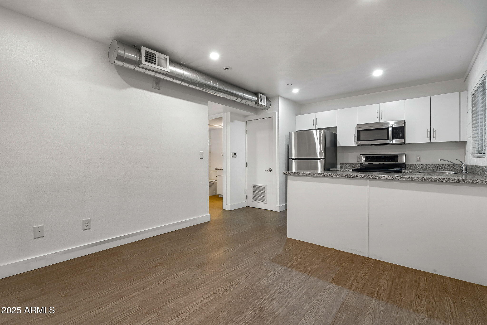 622 North 9th Avenue, Unit 101 Phoenix, AZ 85007 - Photo 3 of 18 a view of kitchen with wooden floor