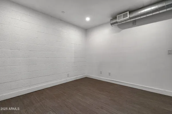a view of a room with wooden floor