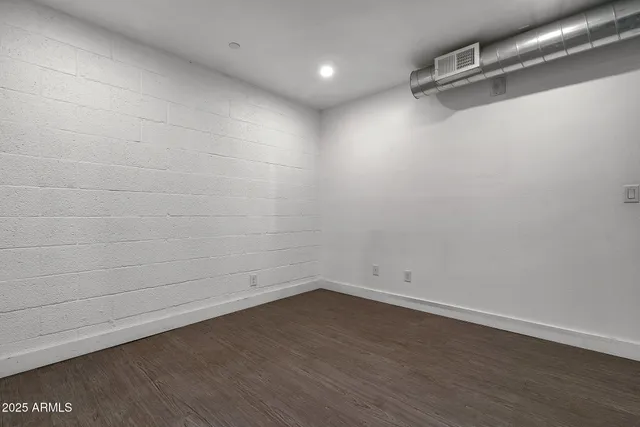 a view of a room with wooden floor