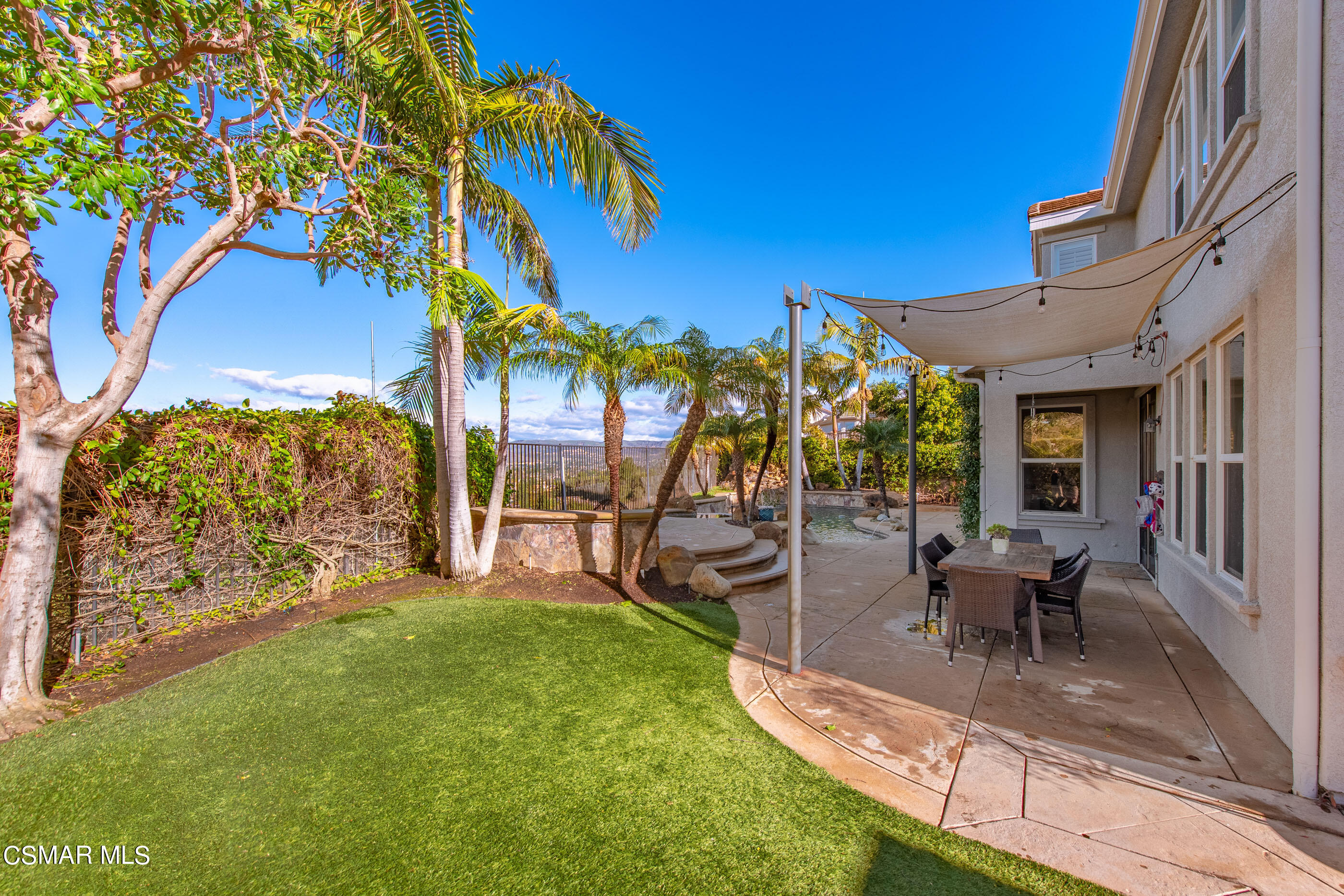 1997 Arielle Lane Simi Valley, CA 93065 - Photo 20 of 54 a view of a patio with table and chairs potted plants and a large tree