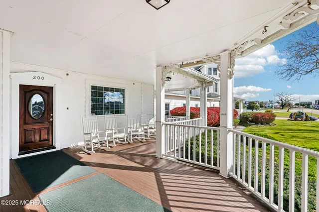 a view of a porch with furniture and garden