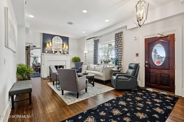a living room with furniture a rug and a fireplace