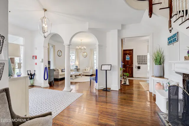 a view of a hallway with dining table and chairs