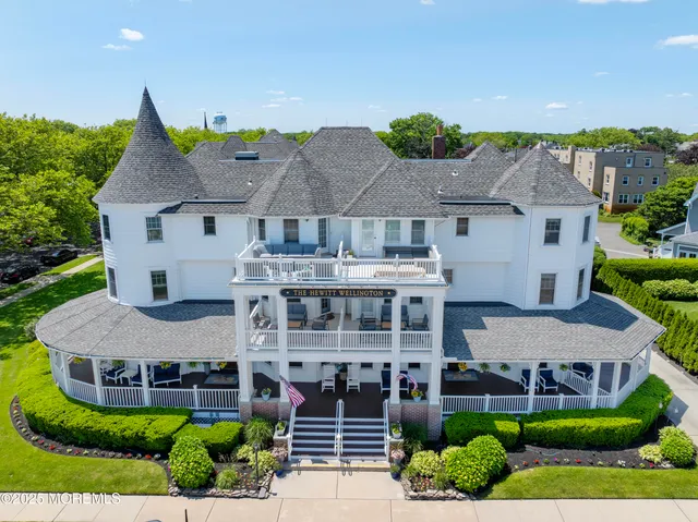 a front view of a building with a garden and plants