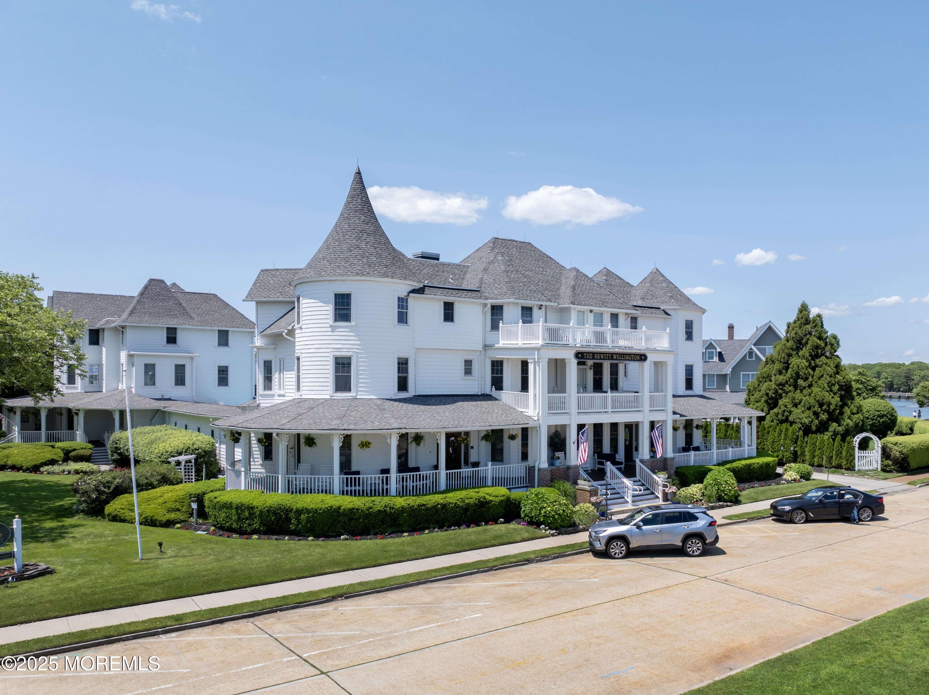 200 Monmouth Avenue, Unit 19 Spring Lake, NJ 07762 - Photo 23 of 28 a front view of a building with a garden and plants
