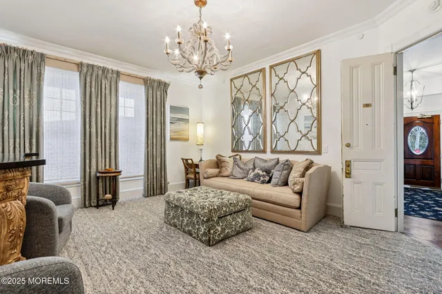 a living room with furniture and a chandelier