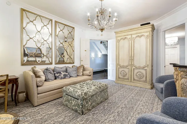 a living room with furniture and a chandelier