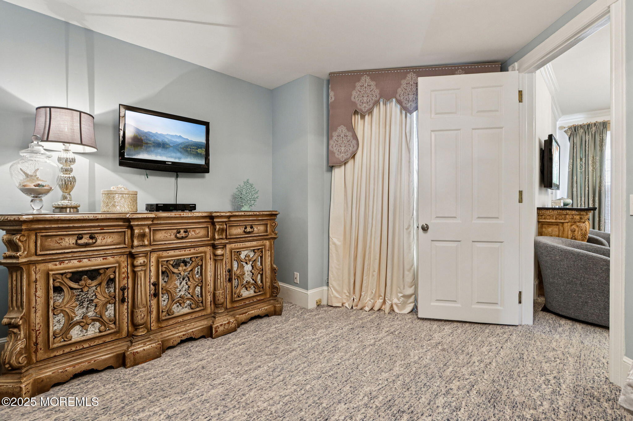 200 Monmouth Avenue, Unit 19 Spring Lake, NJ 07762 - Photo 8 of 28 a living room with furniture a flat screen tv and a refrigerator