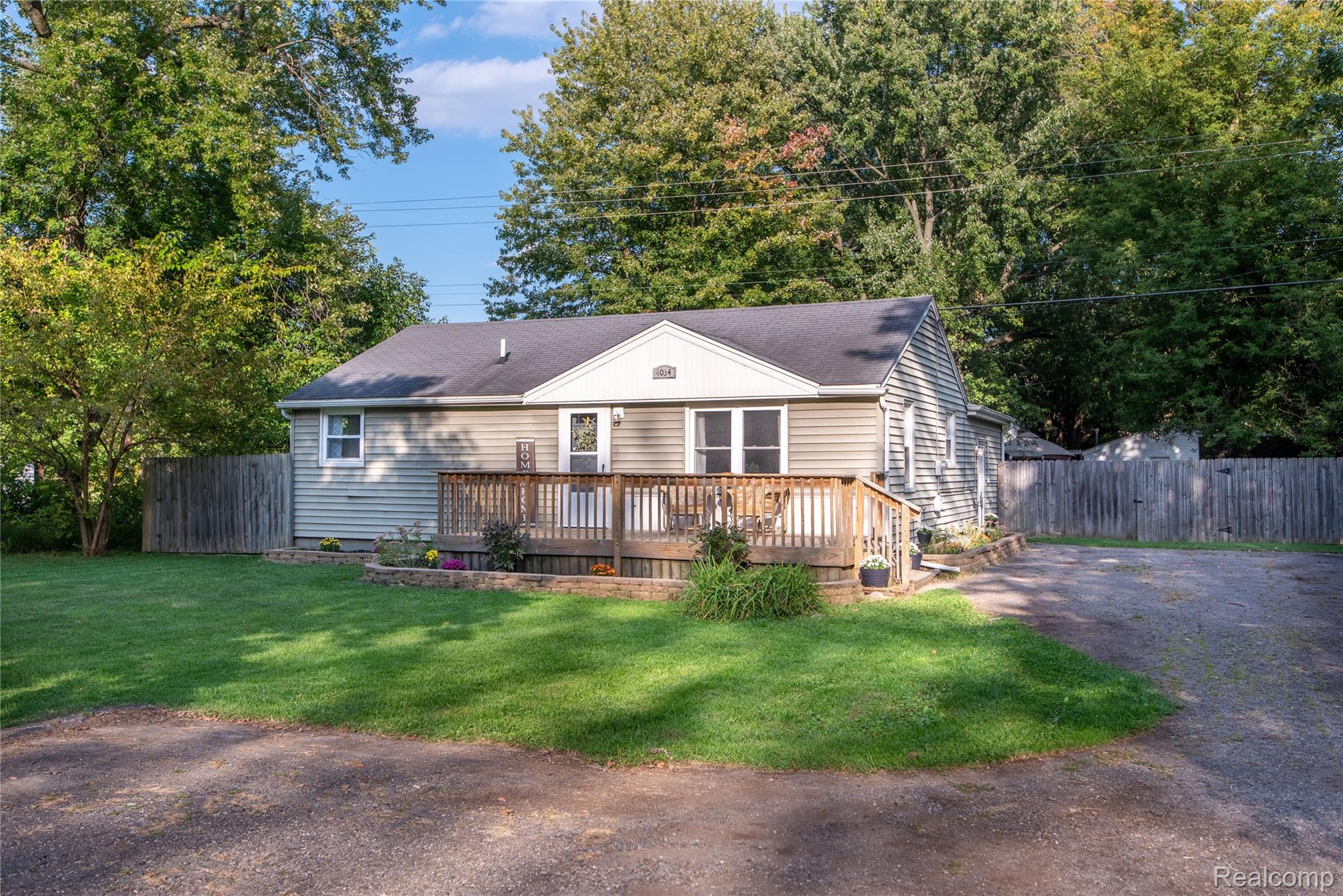 4034 Genesee Flint, MI 48506 - Photo 1 of 36 View of front facade featuring a wooden deck and roof with shingles
