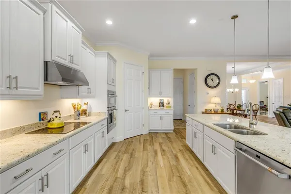 a large kitchen with stainless steel appliances lots of counter space and a sink