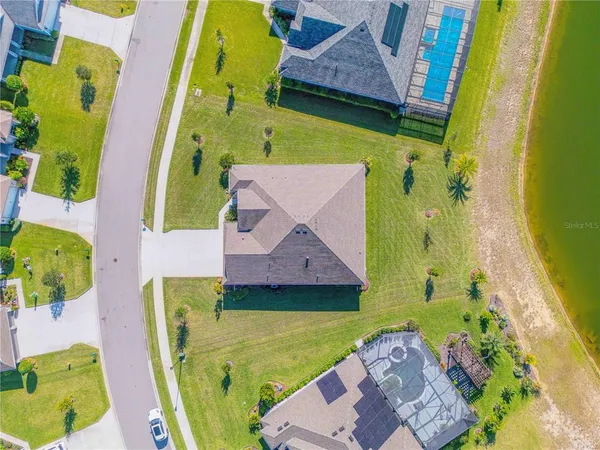 an aerial view of residential building and lake