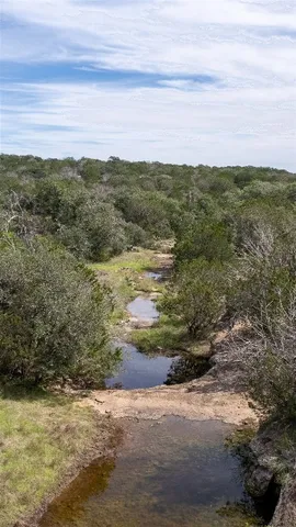 a view of a field with an ocean