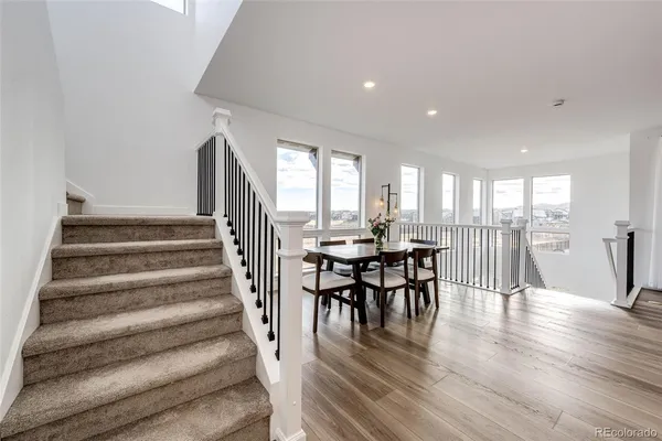 a view of a dining room with furniture and wooden floor
