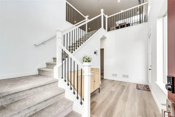 a view of entryway and hall with wooden floor