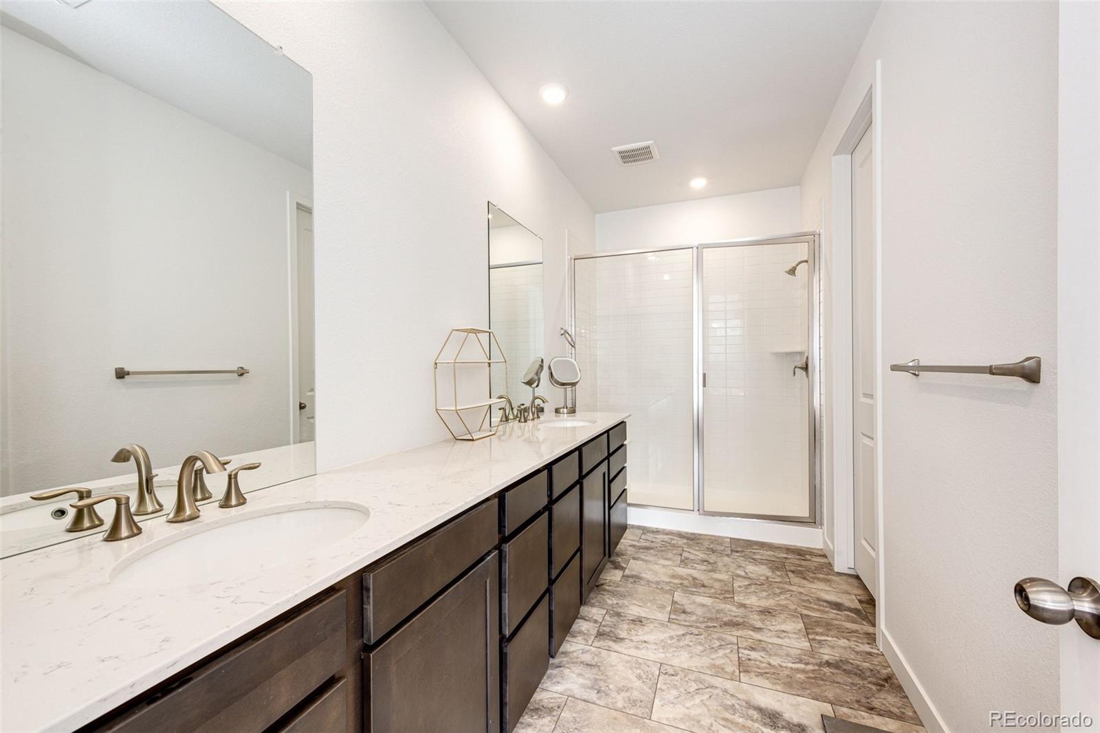 3100 South Russell Street Morrison, CO 80465 - Photo 24 of 29 a bathroom with double vanity sink and a mirror