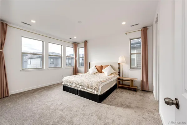 a living room with a bed furniture and a window