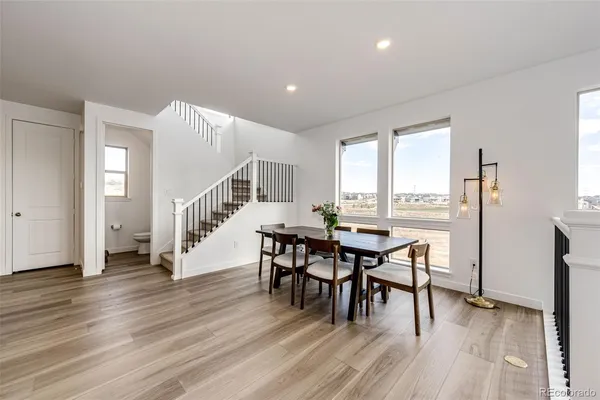 a dining room with furniture and wooden floor