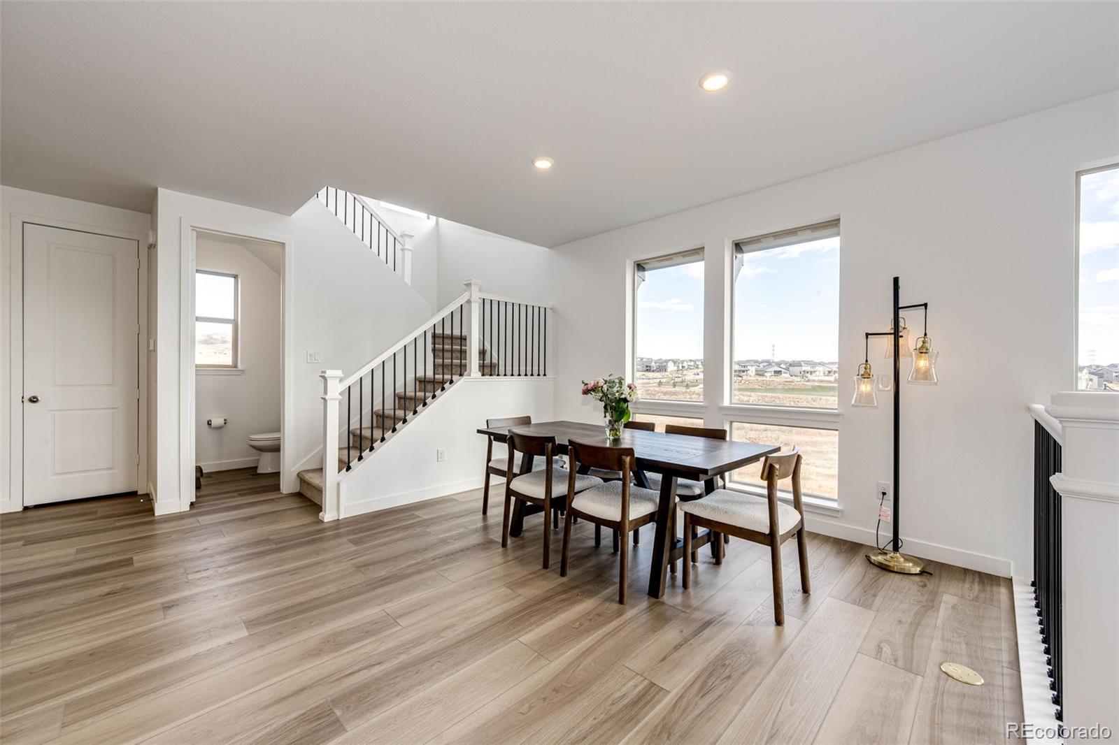 3100 South Russell Street Morrison, CO 80465 - Photo 8 of 29 a dining room with furniture and wooden floor