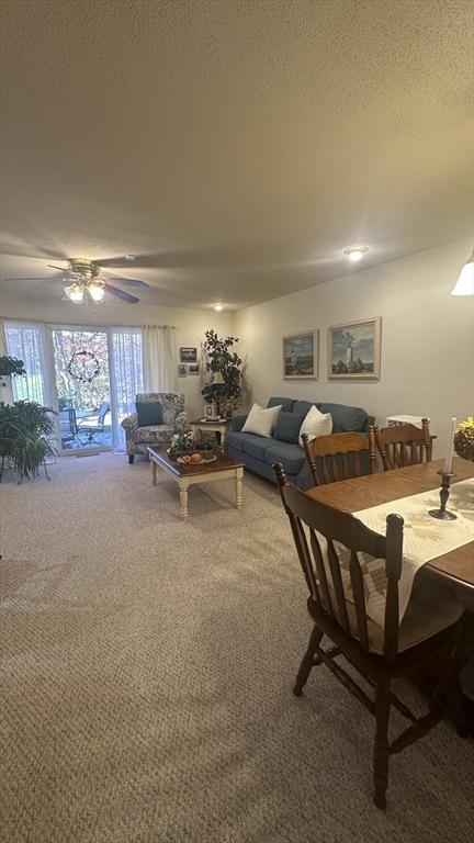 300 Buck Island Road, Unit 14F Yarmouth, MA 02673 - Photo 29 of 29 a living room with furniture kitchen view and a large window