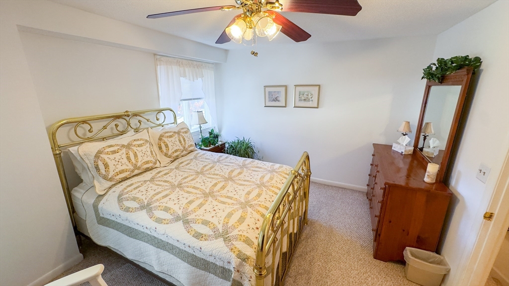 300 Buck Island Road, Unit 14F Yarmouth, MA 02673 - Photo 10 of 29 a bedroom with a bed and wooden floor