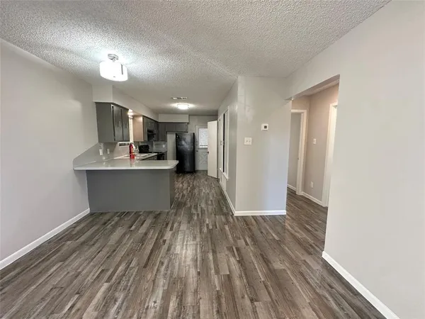 a view of a kitchen with wooden floor and a kitchen