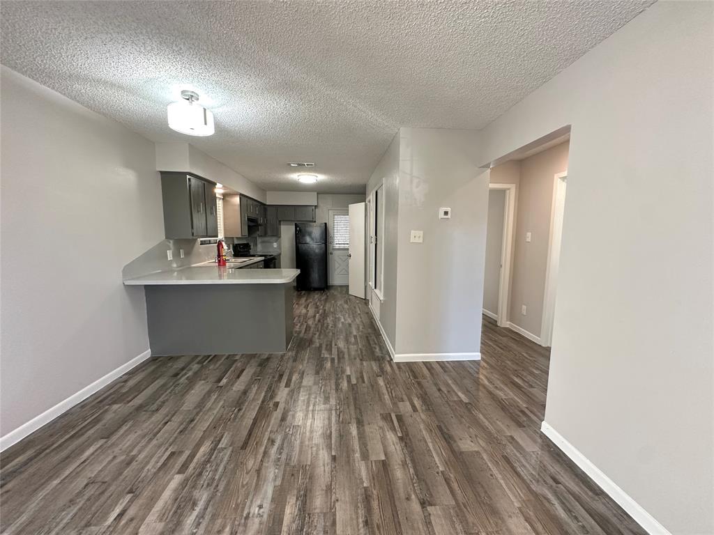 2006 Jane Street, Unit H Longview, TX 75601 - Photo 2 of 12 a view of a kitchen with wooden floor and a kitchen
