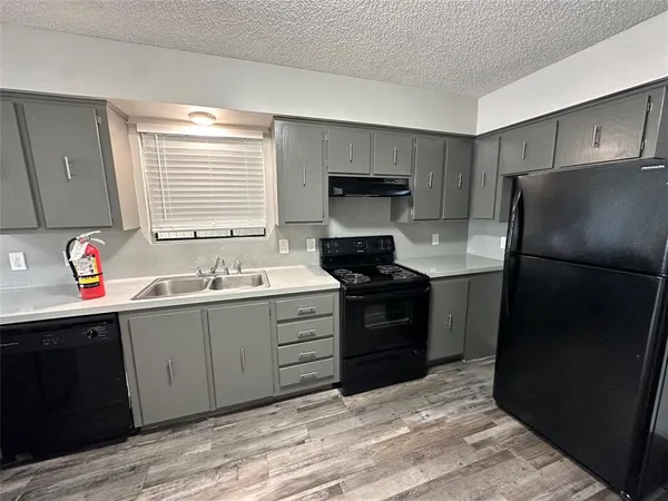 a kitchen with a sink stove and refrigerator