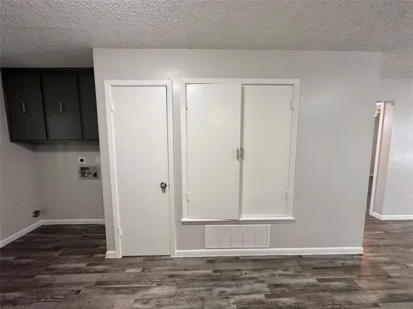 a view of a room with wooden floor
