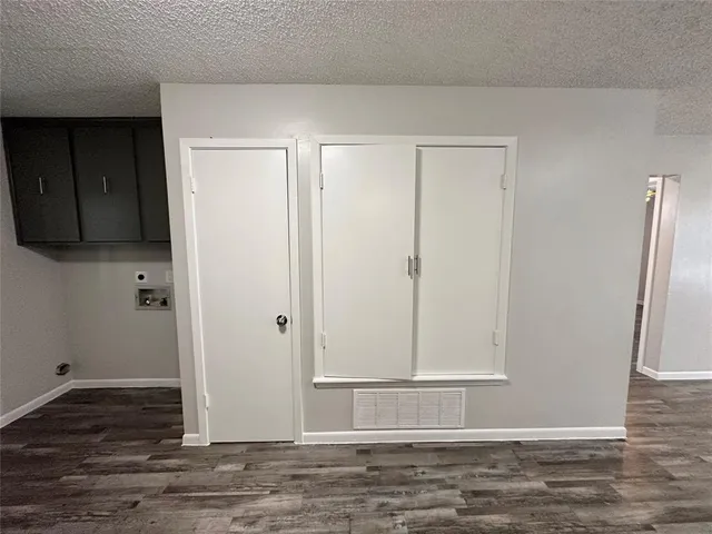 a view of a room with wooden floor