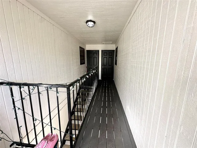 a view of a balcony with wooden floor and stairs